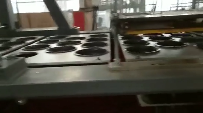 thermoforming machine working with in-line puching machine and robot arm 